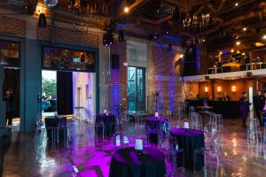 Indoor Reception Lighting Setup - Lombardi House best indoor wedding venues in california Indoor event reception setup with purple uplighting and modern decor.