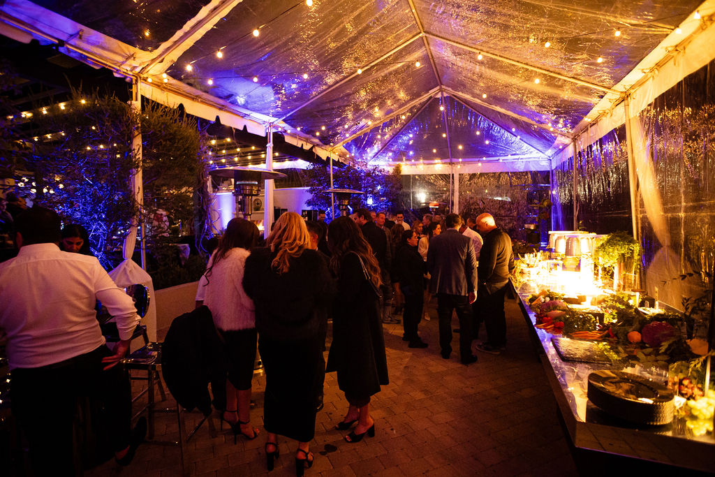 best indoor wedding venues in california Elegant outdoor evening reception with string lights and guests at The Langham Huntington Pasadena